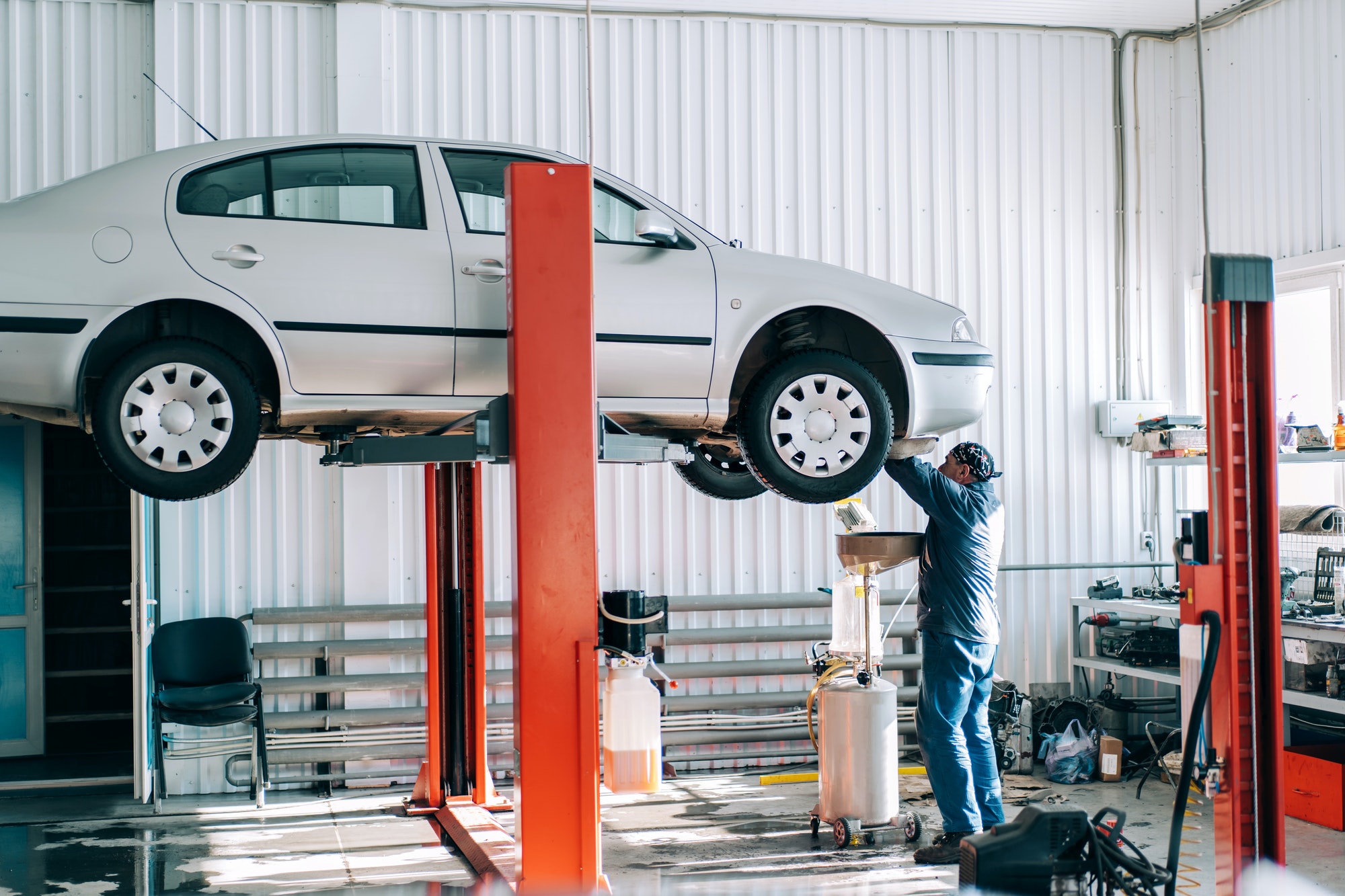 Car lifted on car lift for routine maintenance